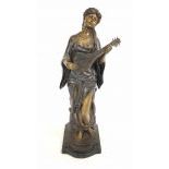 Bronze statue of a woman playing string instrument