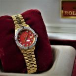  Lady’s watch  ROLEX  in 18ct gold with diamonds and rubies. President wristband. With box....