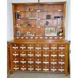 Pharmacy cabinet with 56 drawers and enameled lettering. Ca. 1900. 200x164x43cm