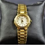 Wristwatch BAUME and MERCIER, completely made of 18ct gold. Nacre clock face with diamonds.