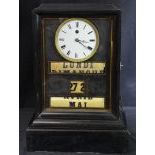 Table pendulum. Black with enameled clock face. Rolling calendar with day, date and month. 47cm high