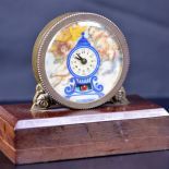 Small table pendulum with painted clock face on marble stand.