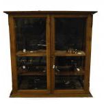 Massive oak wood showcase. Ca. 1900 with a collection of watchmaker tools. 85x85x55