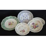  Collection of five carved porcelain plates with polychromatic flower decor, one of which from the...