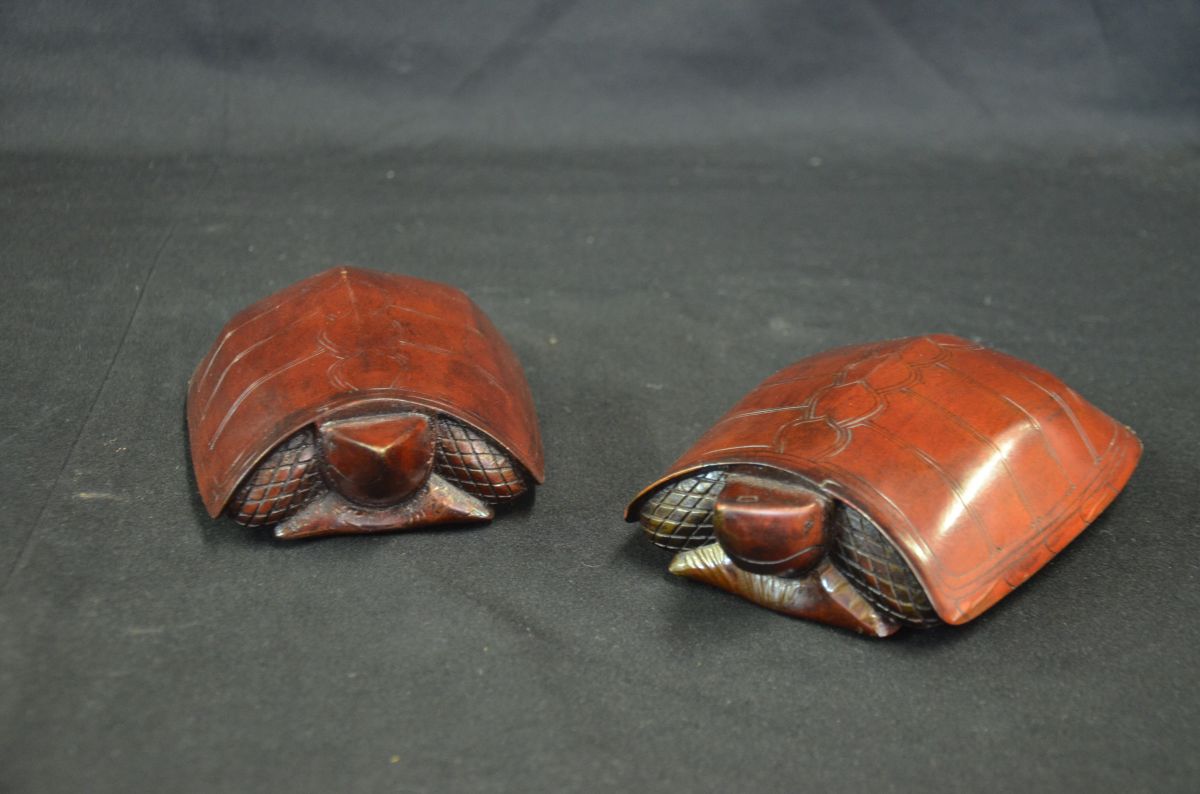  Collection of two turtles carved out of rose wood, made as cans with lids on the foundation to be...