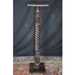  Unturned column of ebonized wood, with hand carved leaf ornaments, height   113,0, width   28,0,...