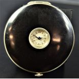 Watch in a form of a powder box, black enameled. Ø 54mm. From the twenties.